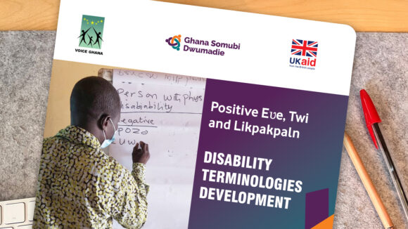 A brochure on the desk with the title 'Disability terminologies development'.